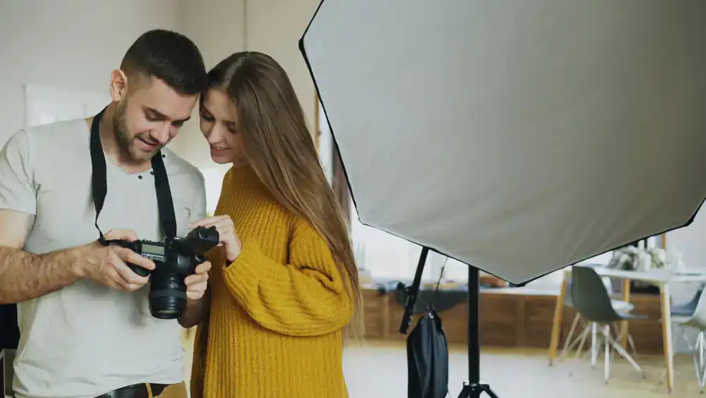 Client reviewing portrait photos in a bright studio