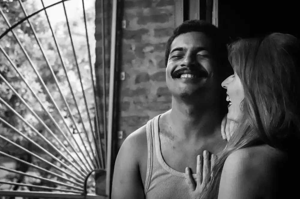 A couple laughing together in black and white